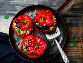 the sweet pepper stuffed with lamb and pearl barley in a vintage frying pan. style vintage. selective focus