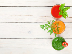 Fresh vegetable smoothie on wooden table. Tomato, cucumber, carrot. Top view with copy space