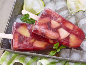 Fresh sangria popsicles with apples, orange and peaches