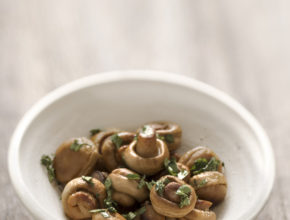 close up of a bowl of sauteed mushrooms